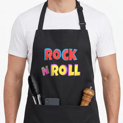 Tablier de cuisine noir avec inscription Rock N Roll en lettres colorées style années soixante-dix.