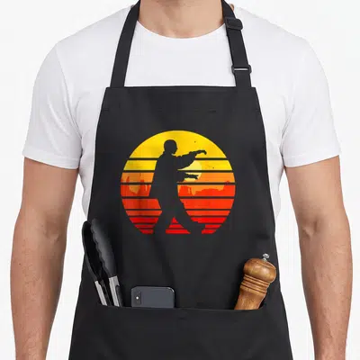 Tablier de cuisine noir avec silhouette Tai Chi sur fond de soleil couchant rétro orange et rouge strié.