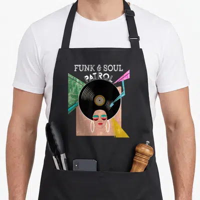 Tablier de cuisine noir avec illustration rétro d'un vinyle et d'une femme aux lunettes de soleil.