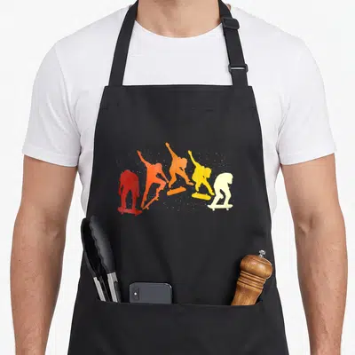 Tablier de cuisine noir avec silhouettes de skateurs colorées en dégradé rétro.