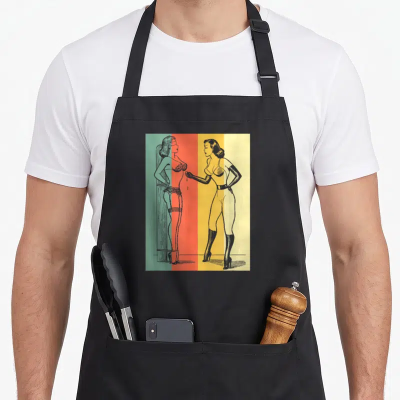 Tablier de cuisine noir avec illustration Pin UpGirl en lingerie rétro et scène de bondage sur fond coloré.