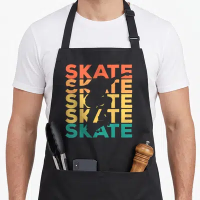 Tablier de cuisine noir avec silhouette de skateur en négatif sur le mot Skate répété en lettres colorées dégradées.