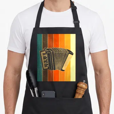 Tablier de cuisine noir avec illustration d'accordéon styrien rétro sur fond de bandes colorées vertes et oranges.