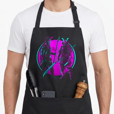 Tablier de cuisine noir avec illustration d'un spartiate et d'un samouraï face à face sur fond rose et cyan.