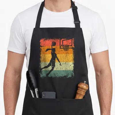 Tablier de cuisine noir avec silhouette femme basketball et panier sur fond bandes colorées délavées