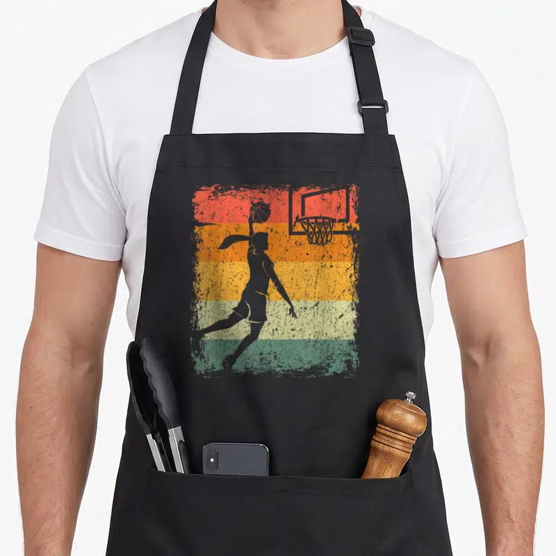 Tablier de cuisine noir avec silhouette femme basketball et panier sur fond bandes colorées délavées