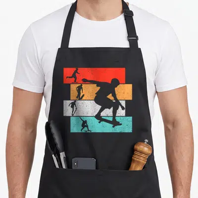 Tablier de cuisine noir avec silhouettes skaters sur bandes colorées orange turquoise et gris style rétro.