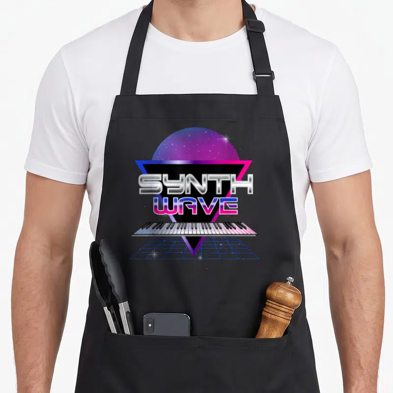 Tablier de cuisine noir avec illustration synthwave clavier et soleil étoilé coloré.