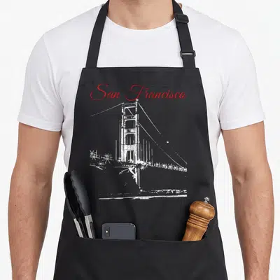 Tablier de cuisine noir avec illustration blanche du pont Golden Gate et texte rouge San Francisco en haut.