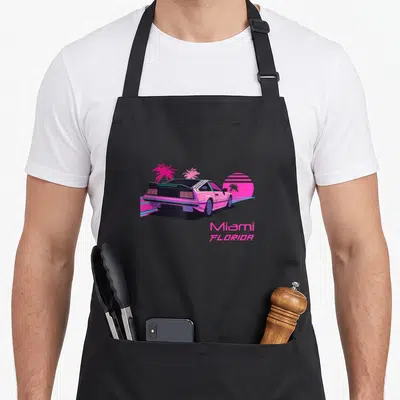 Tablier de cuisine noir avec illustration d'une voiture rose neon, palmiers et texte Miami Florida en rose.