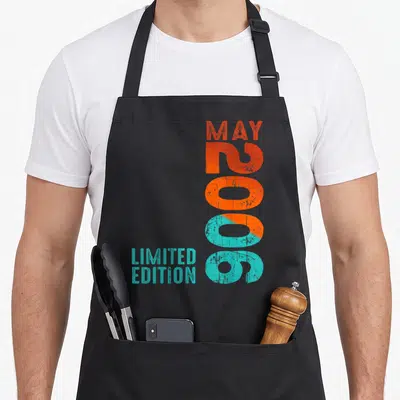 Tablier de cuisine noir avec inscription verticale Mai 2006 Limited Edition en orange et turquoise.
