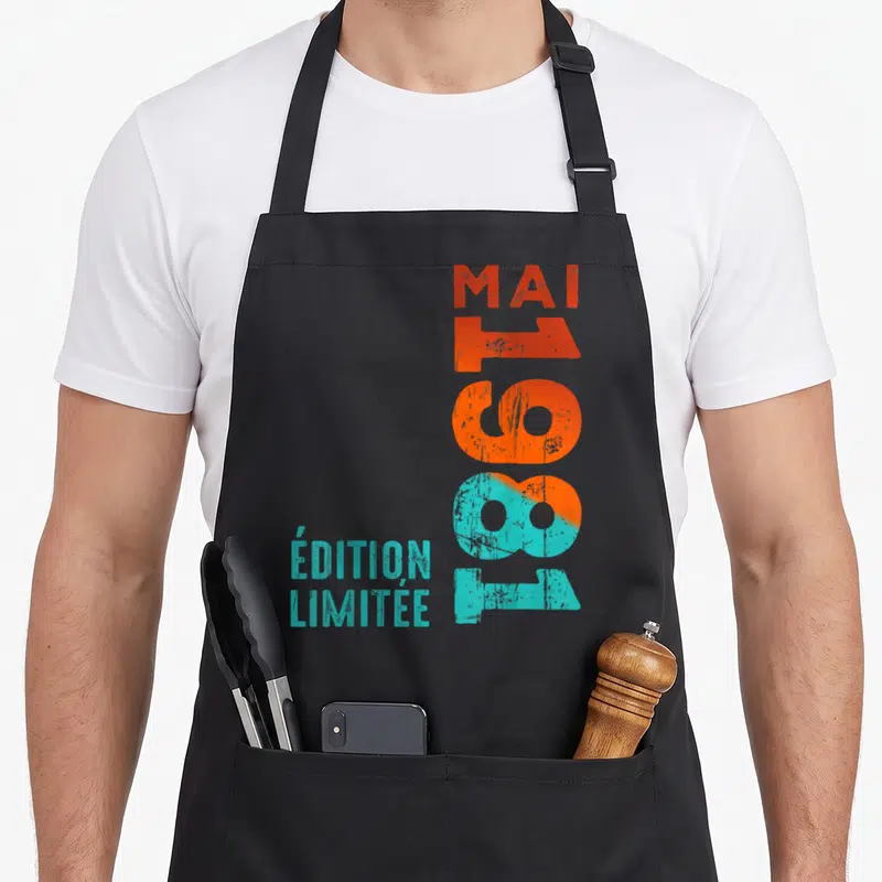 Tablier de cuisine noir avec inscription verticale mai 1981 en orange et turquoise