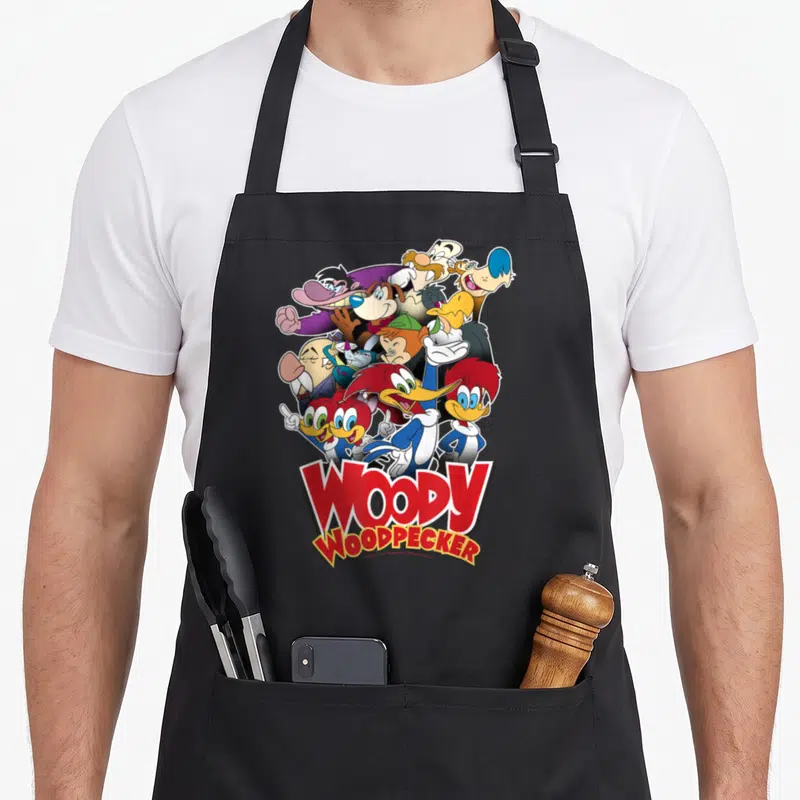 Tablier de cuisine noir avec une illustration groupée de Woody Woodpecker et ses personnages animés en style vintage.