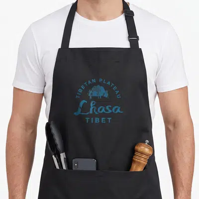 Tablier de cuisine noir avec illustration bleue d'un yak et texte Lhasa Tibet