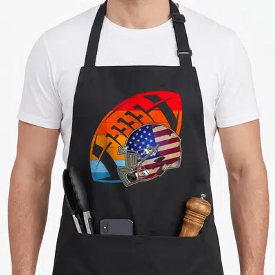 Tablier de cuisine noir avec illustration d'un casque de football américain rétro aux couleurs du drapeau américain.