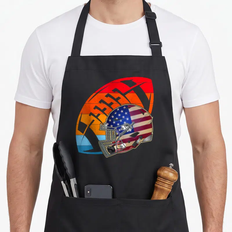 Tablier de cuisine noir avec illustration d'un casque de football américain rétro aux couleurs du drapeau américain.