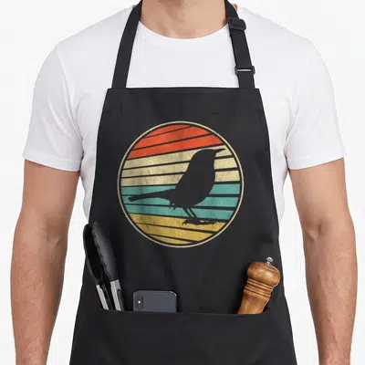 Tablier de cuisine noir avec silhouette d'oiseau sur fond circulaire rayé orange jaune et turquoise
