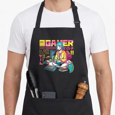 Tablier de cuisine noir avec une illustration d'une fille gamer aux cheveux bleus entourée de consoles et de cartridges de jeux vidéo.