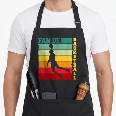 Tablier de cuisine noir avec silhouette de basketteur et texte Fan de Basket retro.
