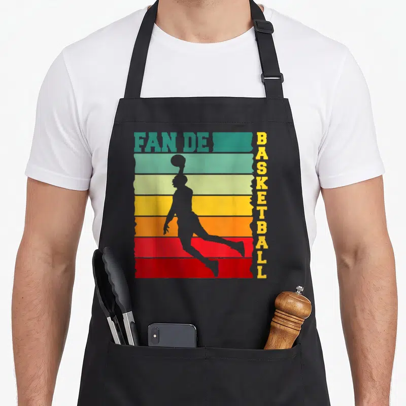 Tablier de cuisine noir avec silhouette de basketteur et texte Fan de Basket retro.
