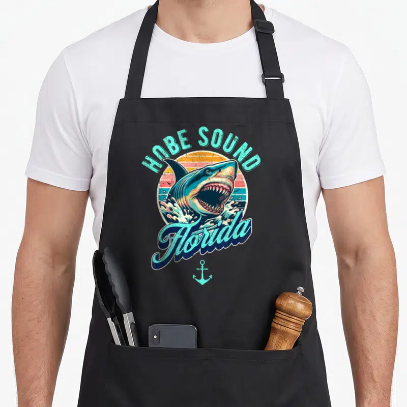 Tablier de cuisine noir avec illustration rétro d'un requin et texte Hobe Sound Florida.