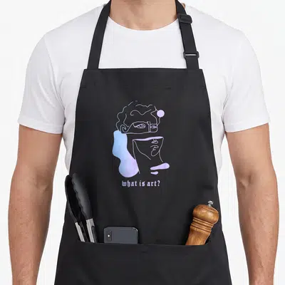 Tablier de cuisine noir avec un portrait stylisé de Michelangelo en violet et bleu et le texte what is art ?