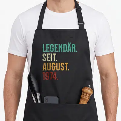 Tablier de cuisine noir avec inscription colorée Légendaire Seit August 1974 style rétro délavé.