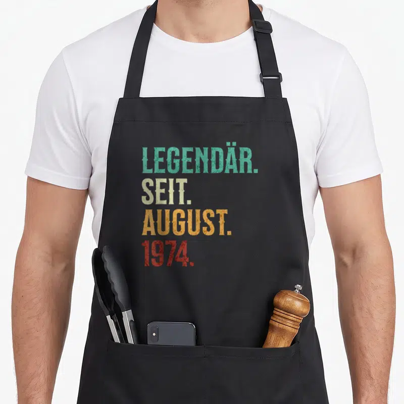 Tablier de cuisine noir avec inscription colorée Légendaire Seit August 1974 style rétro délavé.