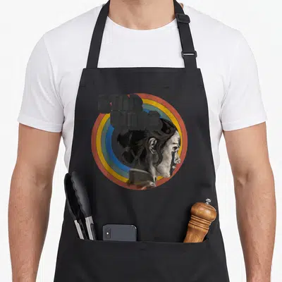 Tablier de cuisine noir avec illustration rétro de Rey et logo Star Wars dans un cercle coloré.