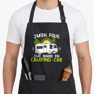 Tablier de cuisine noir avec illustration d'un camping-car blanc, de palmiers et du texte j'en fous je me barre en camping-car.