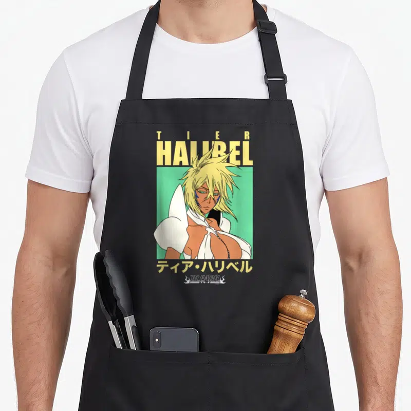 Tablier de cuisine noir avec illustration de Tier Harribel aux cheveux blonds sur fond vert et texte jaune.