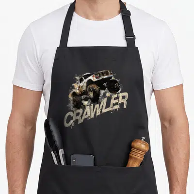 Tablier de cuisine noir avec illustration d'un crawler RC offroad et le texte CRAWLER en lettres délavées.