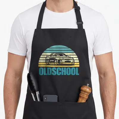 Tablier de cuisine noir avec illustration de voiture tuner Oldschool sur fond rayé turquoise et jaune.