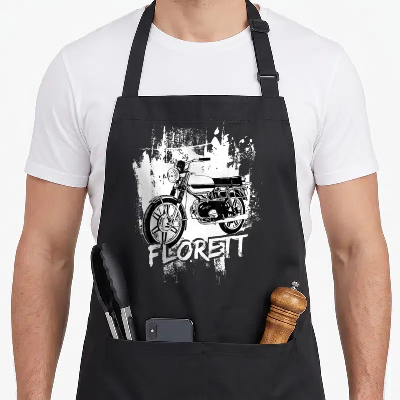 Tablier de cuisine noir avec illustration blanche d'un cyclomoteur Kreidler Florett et le texte Florett en bas.