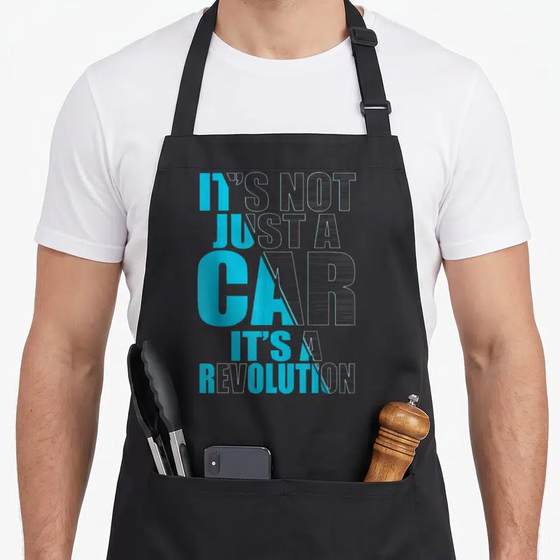Tablier de cuisine noir avec inscription graphique Il n'est pas juste une car c'est une révolution en bleu cyan et blanc.