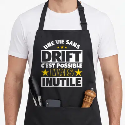 Tablier de cuisine noir avec le texte blanc et jaune Une vie sans Drift c'est possible mais inutile.