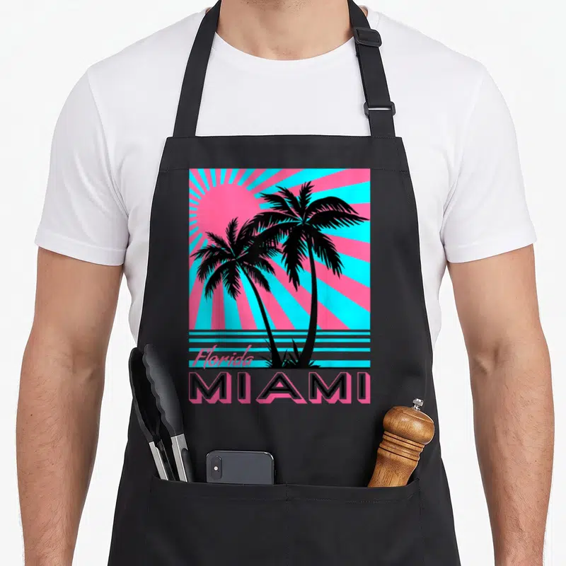 Tablier de cuisine noir avec illustration rétro de palmiers et texte Miami Florida turquoise et rose.
