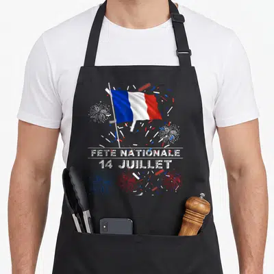 Tablier de cuisine noir orné d'un drapeau français, de feux d'artifice et du texte Fête Nationale 14 Juillet.