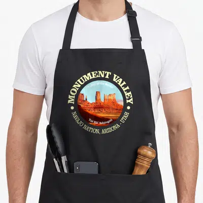 Tablier de cuisine noir avec un motif circulaire représentant le Monument Valley et les inscriptions Navajo Nation Arizona Utah.