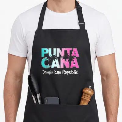 Tablier de cuisine noir avec inscription Punta Cana en lettres colorées et palmiers gris sur fond uni.