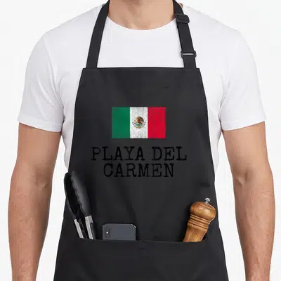 Tablier de cuisine noir avec drapeau mexicain et inscription Playa Del Carmen en lettres noires stylisées.