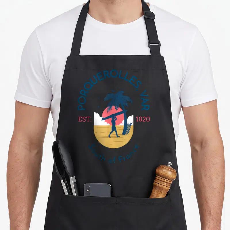 Tablier de cuisine noir avec illustration circulaire Porquerolles Var surfeur palmier et soleil rose