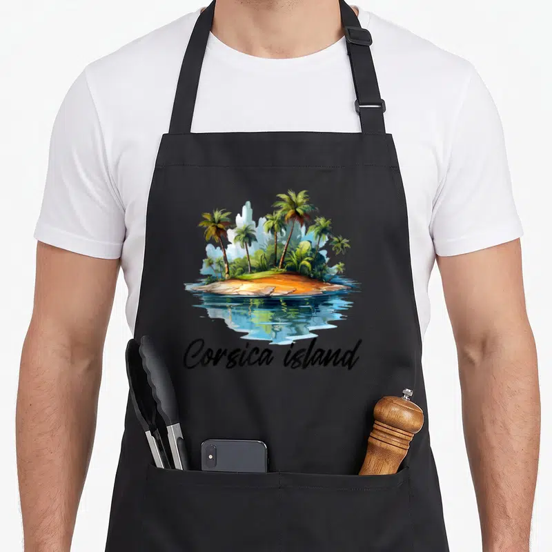 Tablier de cuisine noir avec illustration d'une île tropicale et texte Corsica island en bas.