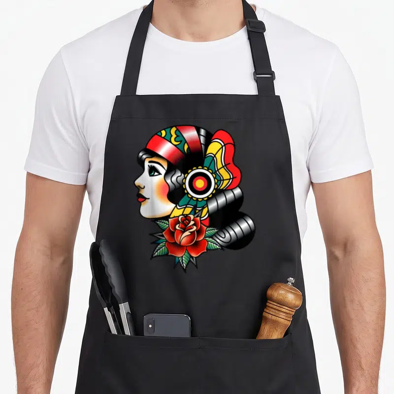 Tablier de cuisine noir avec illustration dame tête tatouage rose rouge et coiffure colorée vintage.