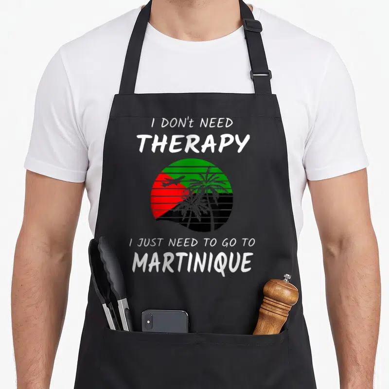 Tablier de cuisine noir avec inscription I DON'T NEED THERAPY et illustration d'un soleil aux couleurs de la Martinique.