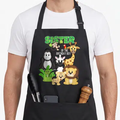 Tablier de cuisine noir avec gorille, lion, girafe et texte Sister of the anniversaire Boy coloré.