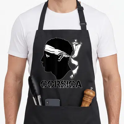 Tablier de cuisine noir avec silhouette tête de Maure et inscription CORSICA en bas.