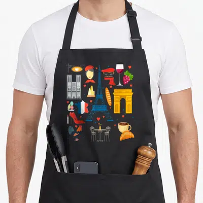 Tablier de cuisine noir avec l'Éiffel, le coq gaulois, le baguette et le vin rouge français en illustration colorée.