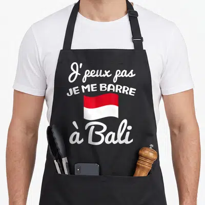 Tablier de cuisine noir avec inscription Je peux pas je me barre à Bali et drapeau indonésien rouge et blanc.