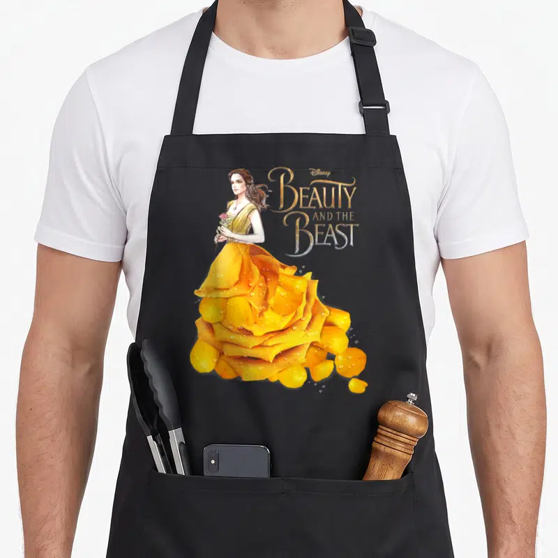 Tablier de cuisine noir avec portrait de Belle en robe rose fleur dorée et titre « Beauty and the Beast »